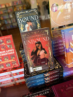 Two stacks of 'Bound' and 'Unbound' novellas by Ali Hazelwood. The cover of 'Unbound' is red with a gold border and an illustrated couple under the title. The cover of 'Bound' is a dark blue background with a gold border and an illustrated couple under the title.