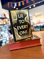 A small stack of the hardcover edition of 'Broken Dove' by Dani Francis without its dust jacket, featuring a black and gold cover with a large gold title.