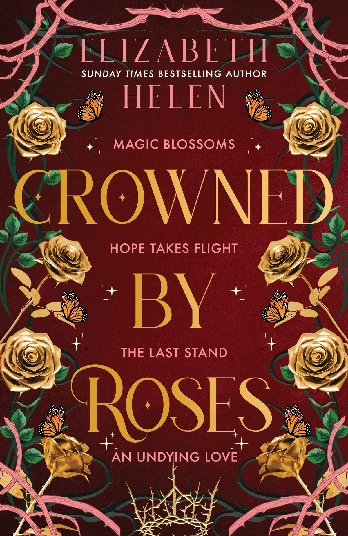 Book cover for 'Crowned by Roses' by Elizabeth Helen, featuring a deep red background with large gold title text, gold roses, green leaves, pink vines, and small orange butterflies.