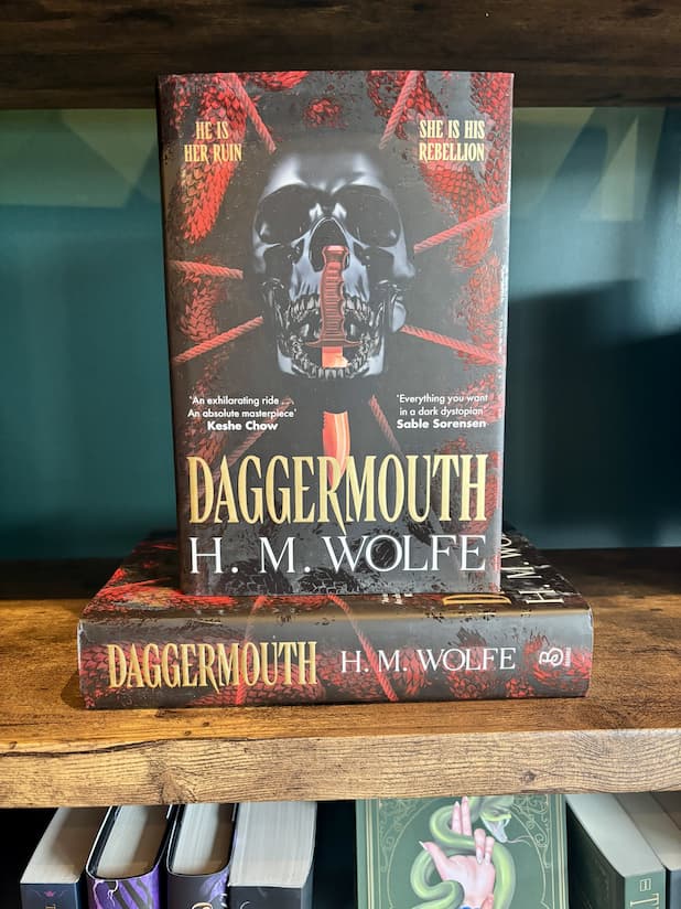 The book 'Daggermouth' by H. M, featuring a black and red background with a black skull in the centre.