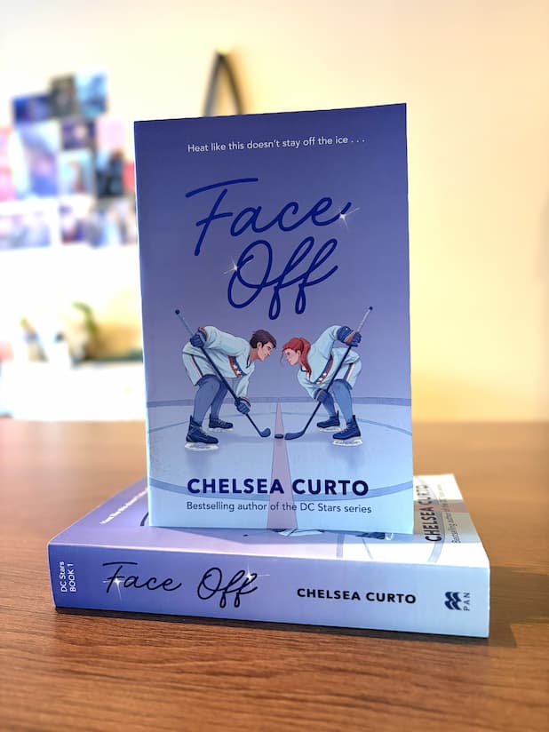 A paperback copy of 'Face Off' from The D.C. Stars Series by Chelsea Curto, featuring two hockey players on an ice rink.