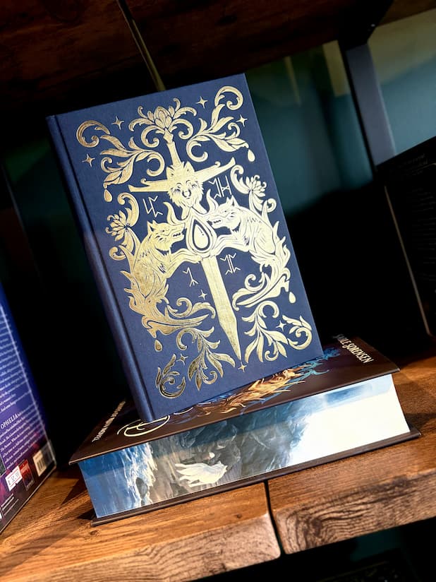 Book cover of 'Fury Bound' by Sable Sorensen featuring a dark blue cover with gold detailing of two head wolf heads holding a gem on top of a sword.