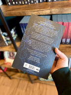 A hand holding a paperback copy of 'Fury Bound' by Sable Sorensen featuring a dark blue background with white text.