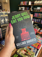 A hand with pink nail polish holding a copy of 'Jenny Will Eat You Now' by Gillian Daniels, featuring a black background, bright green title text, a stylized barred cage, dripping red blood, and white author text.