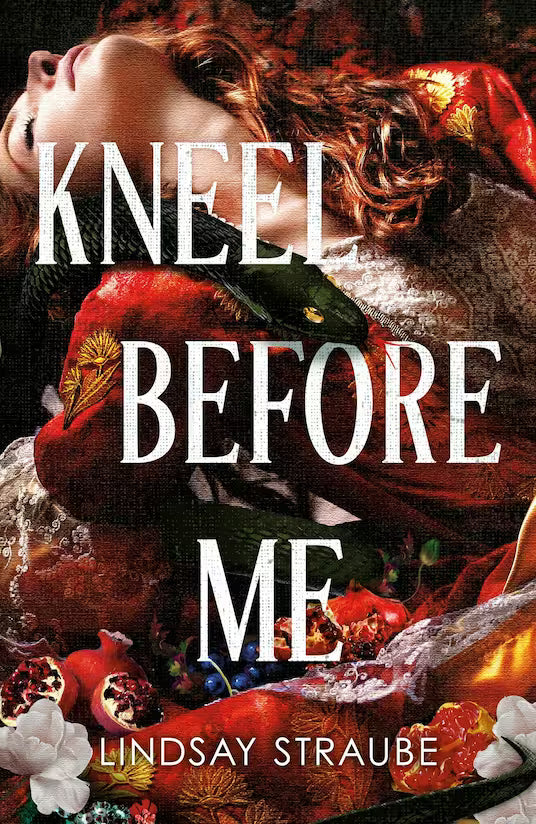 Book cover for 'Kneel Before Me' by Lindsay Straube, featuring a dramatic close-up of a woman with red hair in ornate red clothing, overlaid with large white title text and surrounded by pomegranates, flowers, and metallic decorative elements.
