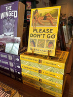 A stack of the book for 'Please Don't Go' by E. Salvador, alternating spine and digitally sprayed edge, the cover features a retro-style illustrated design with a yellow background, green title text, and vintage photographs of the main characters and baseball elements, in front of a blurry bookshelf full of books.