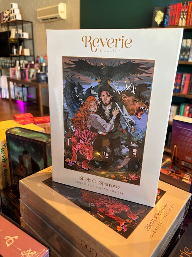 A stack of the officially licensed puzzle of Shield Of Sparrows by Devney Perry by Reverie Puzzles, beautifully illustrated with Odessa, the Guardian, and the monsters that fill their world.