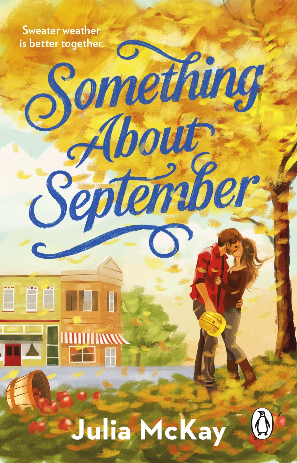 Book cover of 'Something About September' by Julia McKay with a couple kissing under a tree, surrounded by autumn leaves.