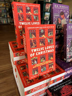 A stack of 'The Twelve Loves of Christmas' featuring a bright red background with illustrated holiday scenes in window frames and large white title text.