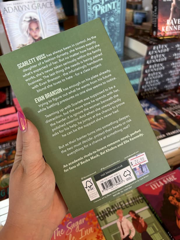 A hand with pink nail polish holds a copy of 'Unravelling' by Janisha Boswell, featuring a green background and white text.
